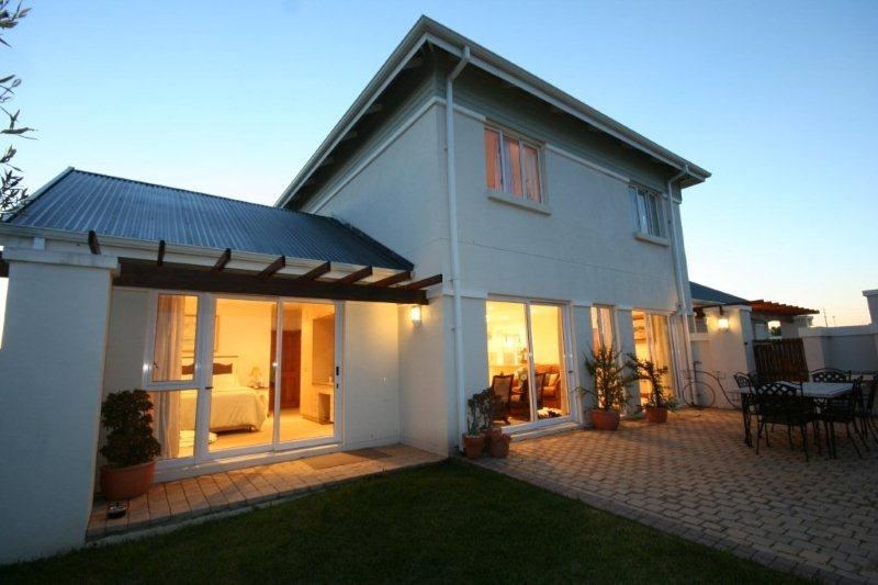Lit double-storey house at dusk