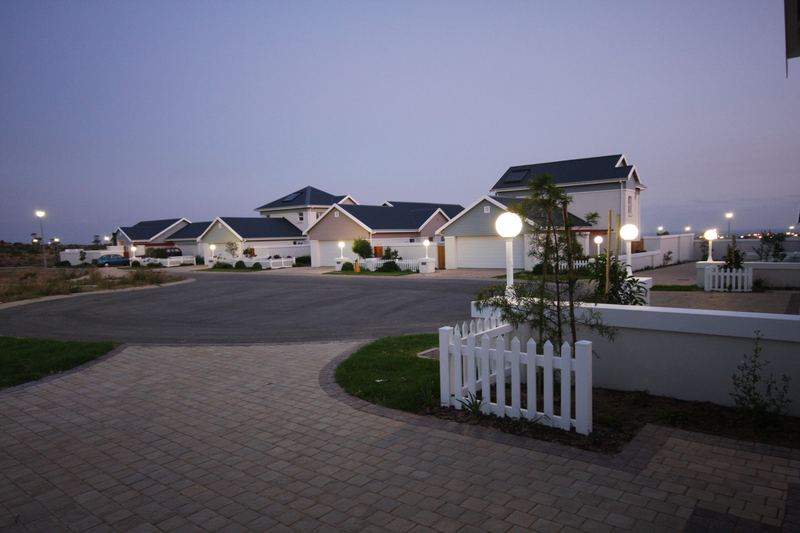 Completed houses around a paved close at dusk